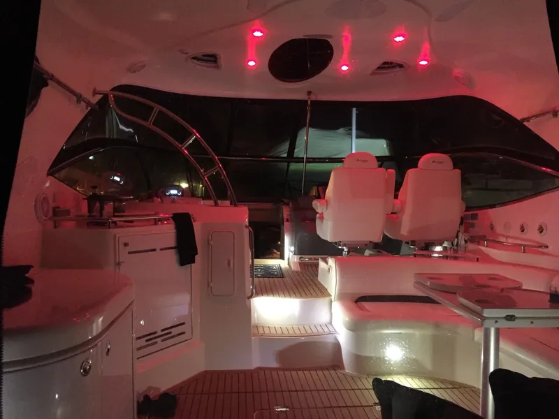 Slide: The Image of Interior of a 2005 Cruisers Yachts 520 Express with red lighting. - 8