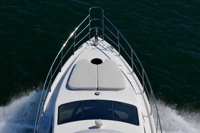 Slide: The Image of Front view of a 2002 Azimut 58 yacht cruising on the water. - 12