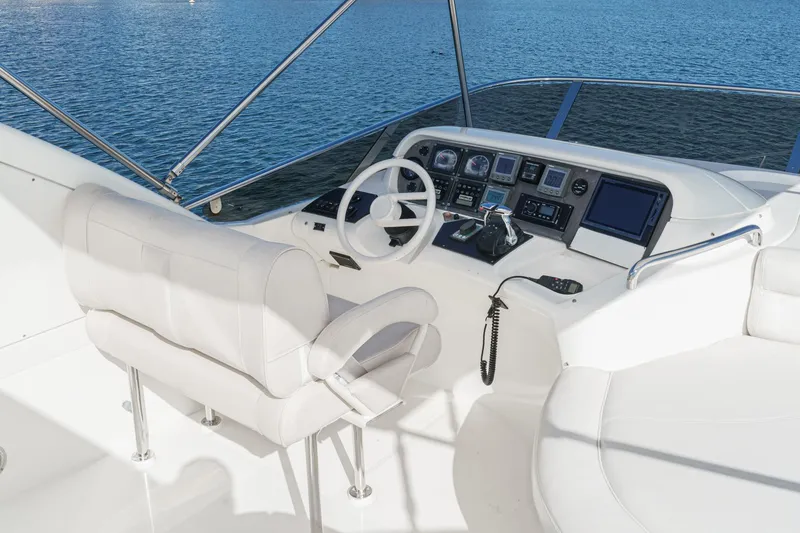 Slide: The Image of Helm of 2002 Azimut 58 yacht with modern controls and white seating. - 16