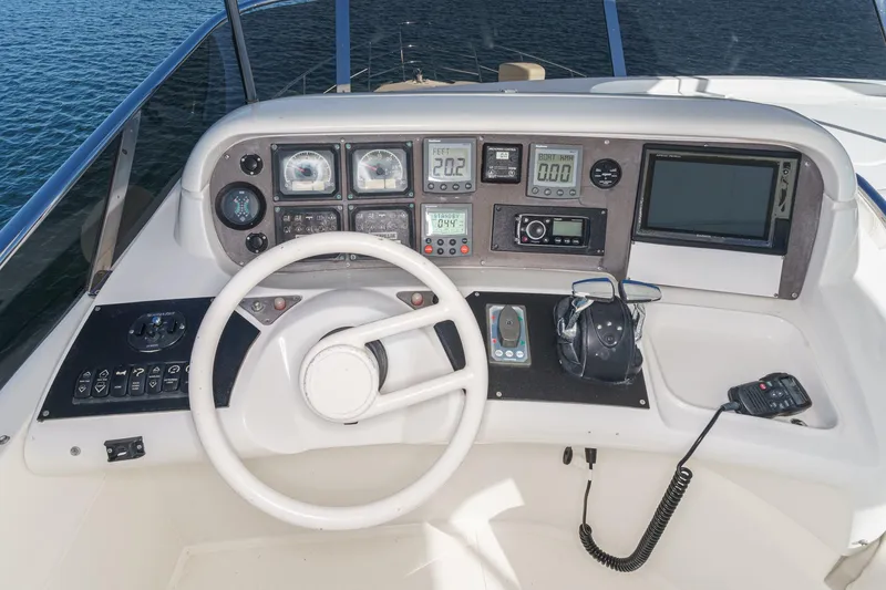 Slide: The Image of Cockpit of a 2002 Azimut 58 yacht with steering wheel and navigation instruments. - 18