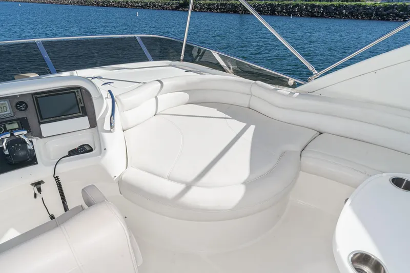 Slide: The Image of Luxurious 2002 Azimut 58 yacht interior with white seating and navigation equipment. - 20