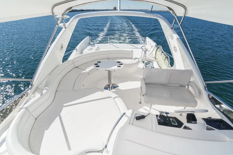 Slide: The Image of Luxurious 2002 Azimut 58 yacht with spacious white seating and ocean view. - 21