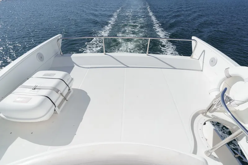 Slide: The Image of Deck view of 2002 Azimut 58 yacht cruising on open water. - 22