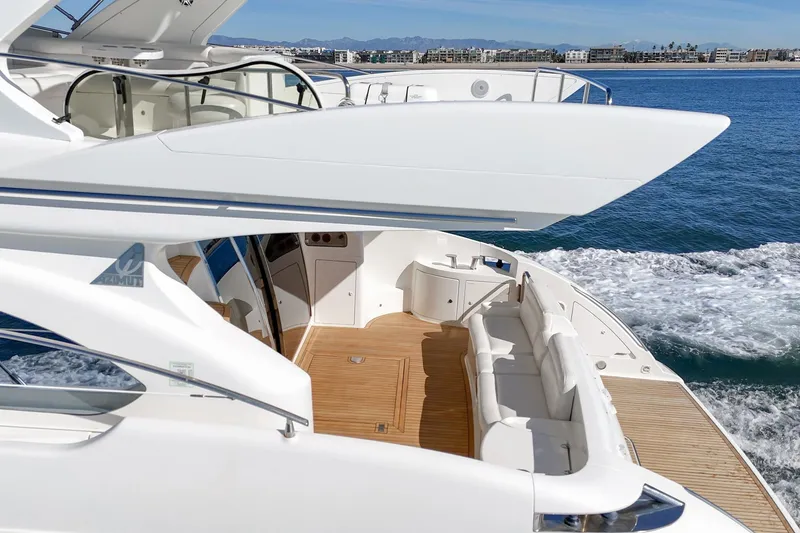 Slide: The Image of Luxurious 2002 Azimut 58 yacht with spacious deck and elegant seating on open water. - 23