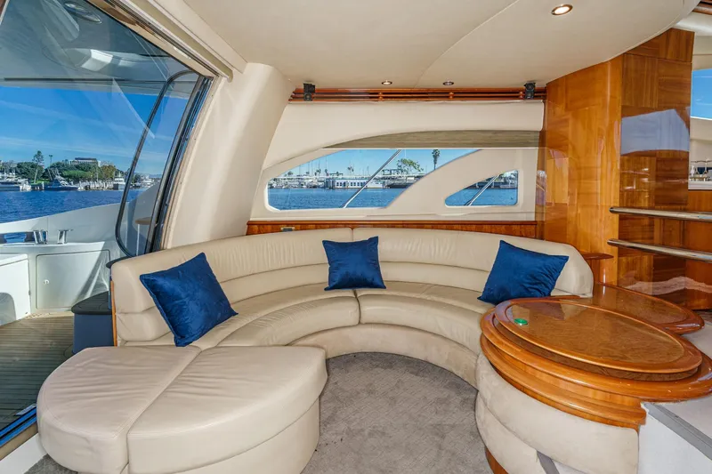 Slide: The Image of Luxurious interior of 2002 Azimut 58 yacht with curved seating and blue cushions. - 30