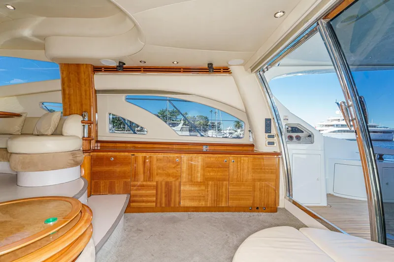 Slide: The Image of Luxurious interior of a 2002 Azimut 58 yacht with elegant wood finishes and plush seating. - 31