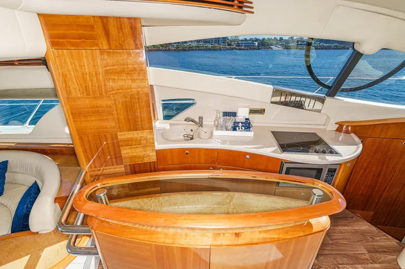 Slide: The Image of Luxurious interior of a 2002 Azimut 58 yacht with wooden finishes and modern kitchen amenities. - 35