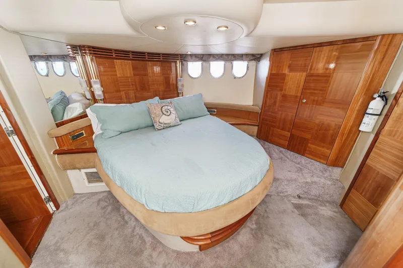 Slide: The Image of Luxurious 2002 Azimut 58 yacht bedroom with elegant wood finishes and plush bedding. - 41