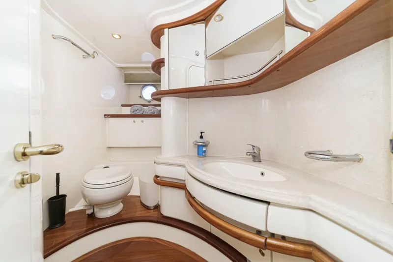 Slide: The Image of Luxurious bathroom interior of a 2002 Azimut 58 yacht, featuring elegant wood accents. - 43