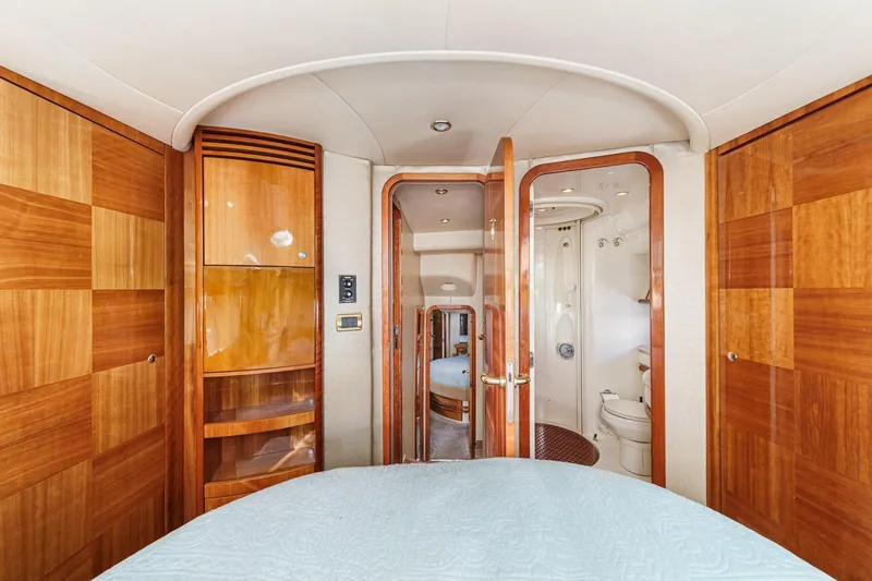 Slide: The Image of Luxurious interior of a 2002 Azimut 58 yacht, featuring wood paneling and modern amenities. - 46
