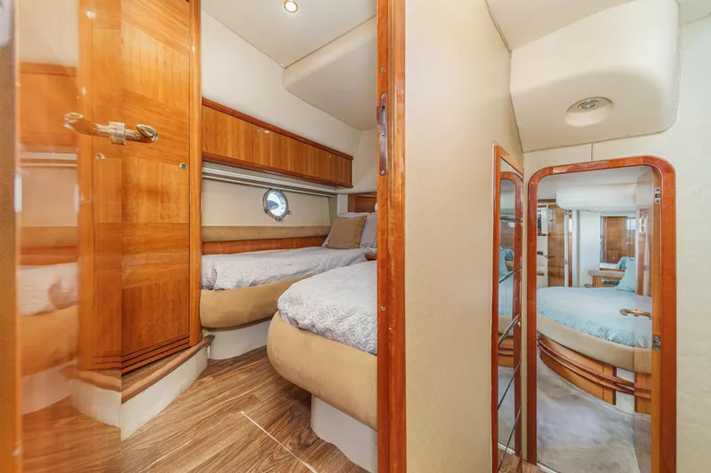 Slide: The Image of Luxurious interior of 2002 Azimut 58 yacht with cozy bedrooms and elegant wood finishes. - 48