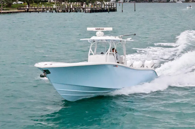 Slide: The Image of 2021 Yellowfin 36 Offshore boat cruising on turquoise water. - 14