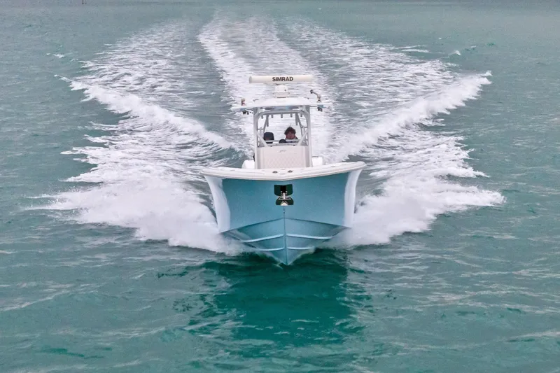 Slide: The Image of 2021 Yellowfin 36 Offshore boat cruising on open water, creating a dynamic wake. - 15