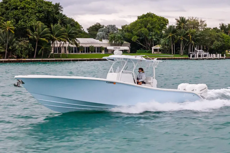 Slide: The Image of 2021 Yellowfin 36 Offshore boat cruising on a scenic waterway. - 16
