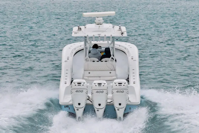 Slide: The Image of 2021 Yellowfin 36 Offshore boat cruising on open water, rear view. - 17