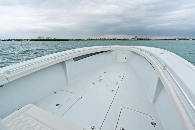 Slide: The Image of 2021 Yellowfin 36 Offshore boat on calm waters under cloudy skies. - 18
