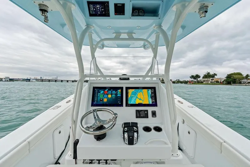 Slide: The Image of 2021 Yellowfin 36 Offshore boat helm with navigation screens and steering wheel. - 24