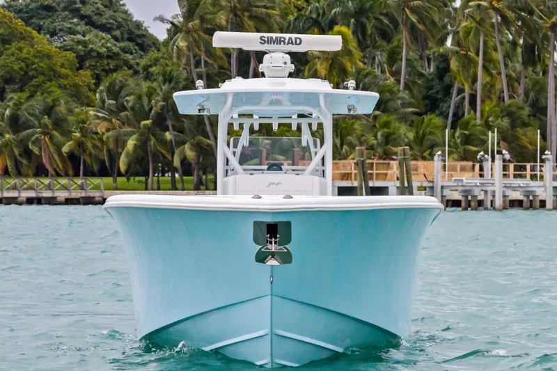 Slide: The Image of 2021 Yellowfin 36 Offshore boat on water, surrounded by palm trees. - 3