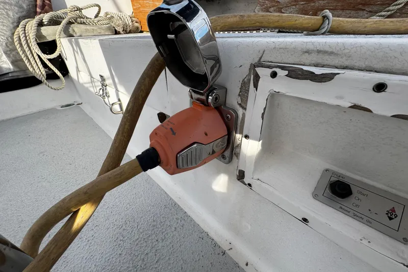 Slide: The Image of 1977 Bristol 29.9 yacht power connection with orange plug and control panel. - 18