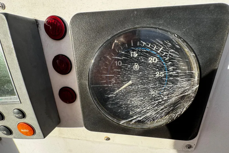 Slide: The Image of Cracked gauge on 1977 Bristol 29.9 dashboard with red indicator lights. - 21