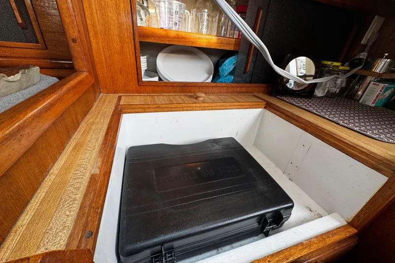 Slide: The Image of 1977 Bristol 29.9 yacht interior with portable gas stove in wooden cabinet. - 31