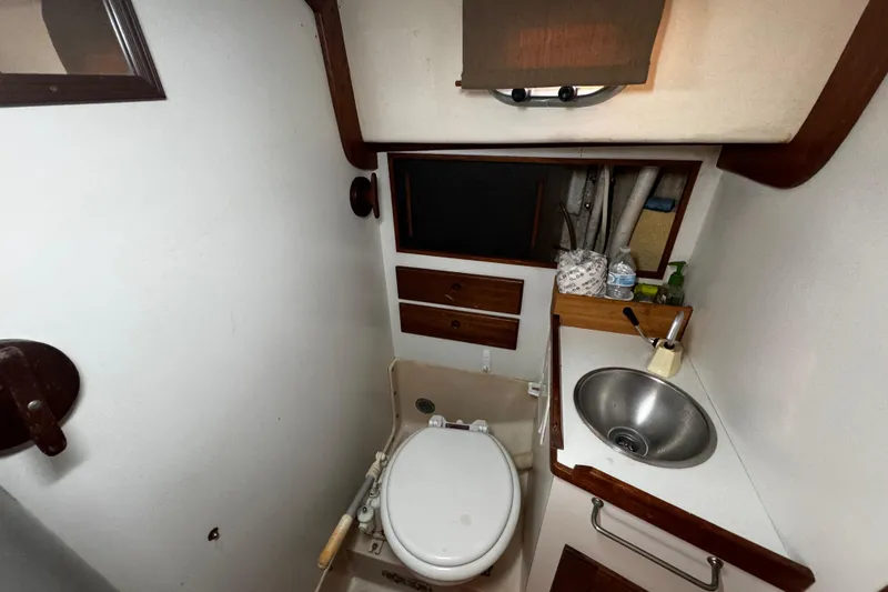 Slide: The Image of 1977 Bristol 29.9 yacht bathroom with compact toilet and stainless steel sink. - 38