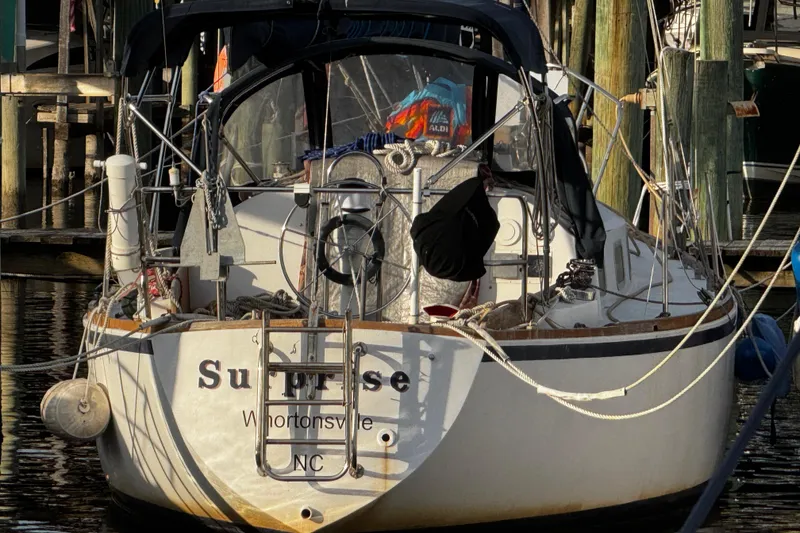 Slide: The Image of 1977 Bristol 29.9 sailboat docked, named "Surprise," stern view - 6