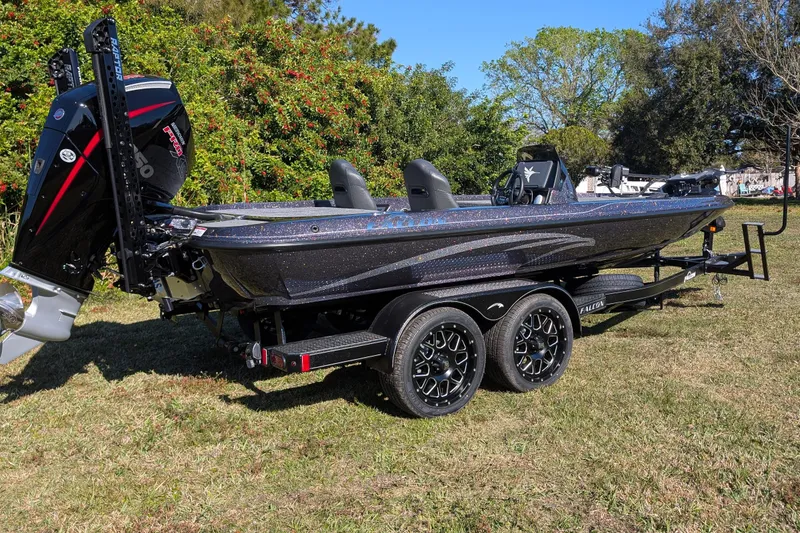 The Image of 2026 Falcon F20 PREDATOR boat on trailer, parked on grass, with powerful outboard motor. - 0