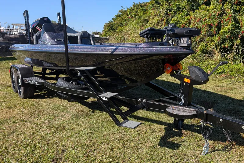 Slide: The Image of 2026 Falcon F20 PREDATOR boat on trailer, parked on grass with lush greenery background. - 6
