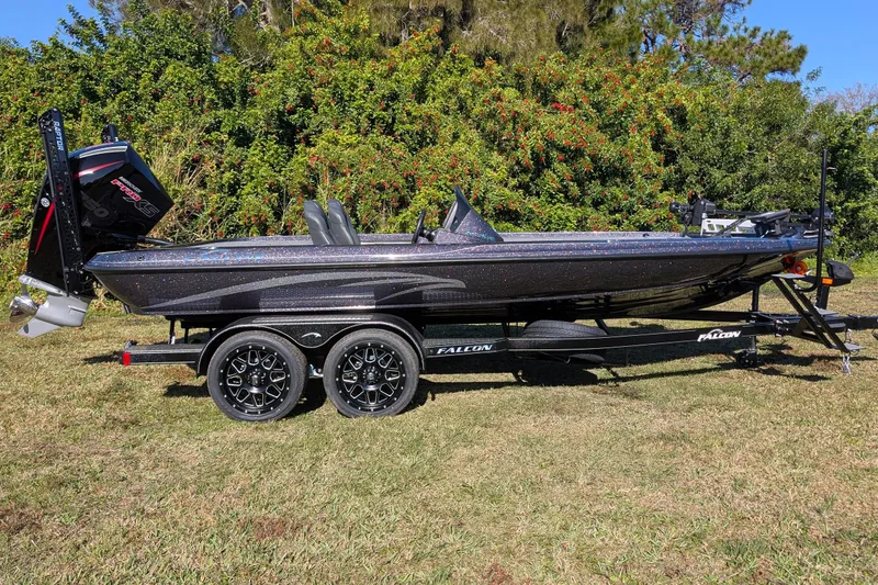 Slide: The Image of 2026 Falcon F20 PREDATOR boat on trailer, parked on grass with lush greenery background. - 4