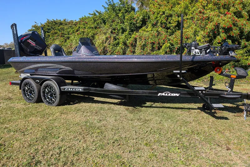 Slide: The Image of 2026 Falcon F20 PREDATOR boat on trailer, parked on grass with lush greenery background. - 5