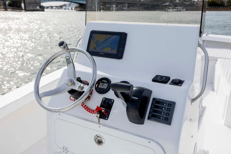 Slide: The Image of Control panel of 2025 Intruder 23 boat with steering wheel and navigation system. - 17