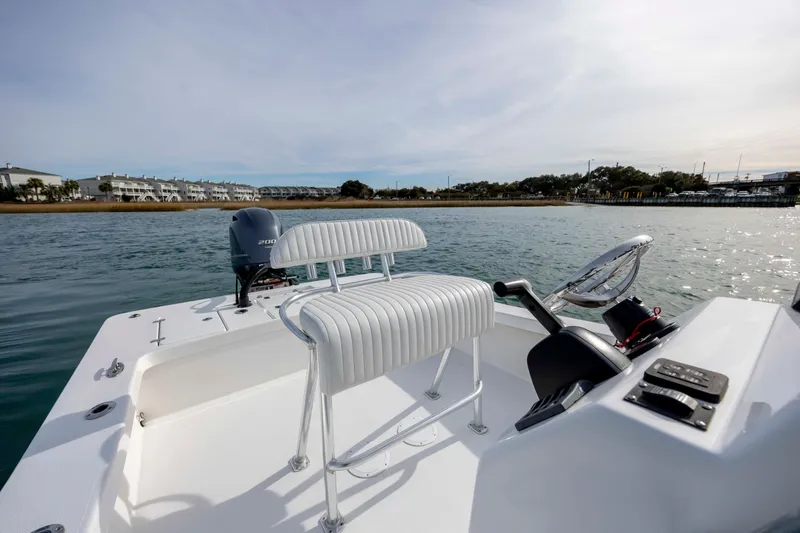 Slide: The Image of 2025 Intruder 23 boat on water, featuring sleek seating and modern controls. - 18