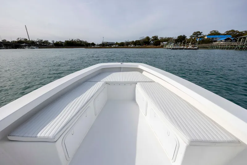 Slide: The Image of Intruder 23 boat 2025 on calm water with seating area. - 22
