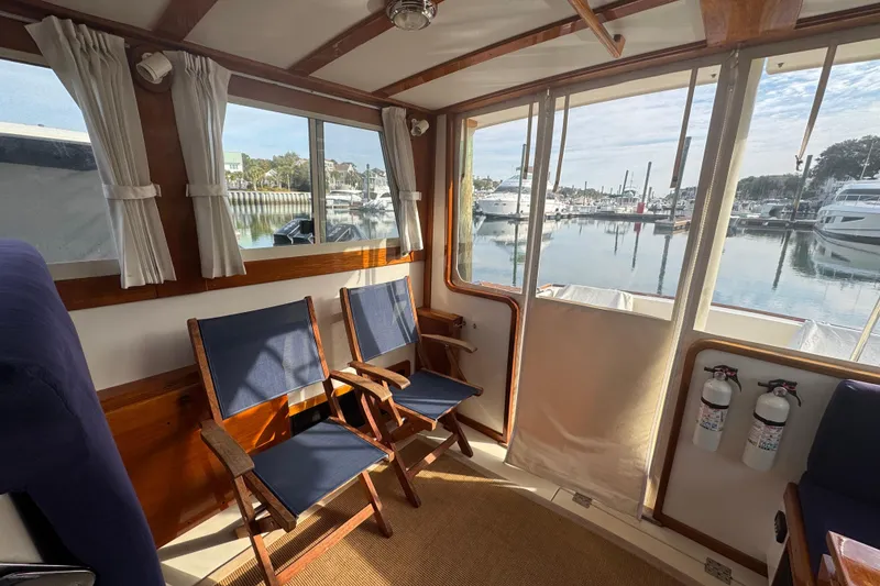Slide: The Image of Interior of 2001 Ellis 36 Flybridge yacht with marina view through windows. - 13