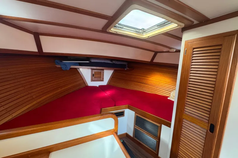 Slide: The Image of Cozy cabin interior of 2001 Ellis 36 Flybridge with red bedding and wooden accents. - 16