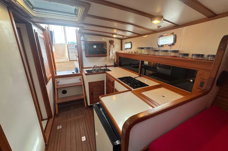 Slide: The Image of 2001 Ellis 36 Flybridge yacht interior with kitchen, wooden cabinetry, and modern appliances. - 18