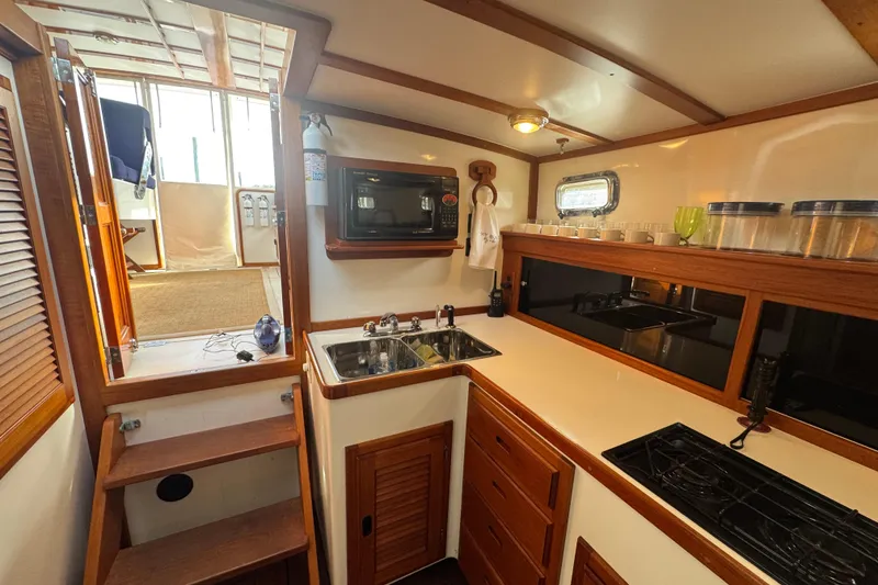 Slide: The Image of 2001 Ellis 36 Flybridge yacht kitchen with wooden cabinetry and modern appliances. - 20