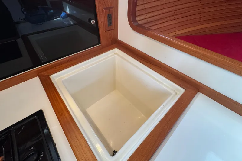Slide: The Image of Interior of 2001 Ellis 36 Flybridge boat featuring a built-in sink with wooden trim. - 23
