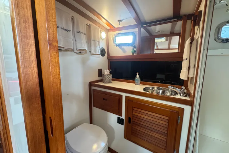 Slide: The Image of Luxurious bathroom interior of 2001 Ellis 36 Flybridge yacht with wooden accents and modern amenities. - 24