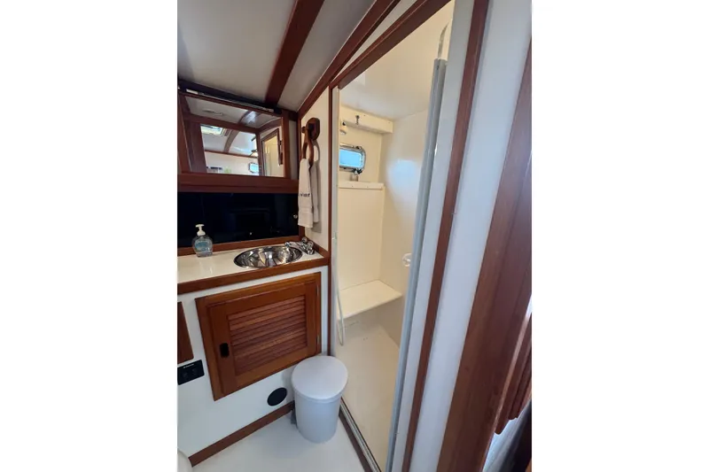 Slide: The Image of Bathroom interior of 2001 Ellis 36 Flybridge yacht, featuring sink and shower. - 25
