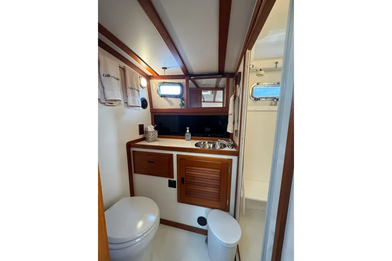 Slide: The Image of 2001 Ellis 36 Flybridge bathroom with wooden accents and compact design. - 26