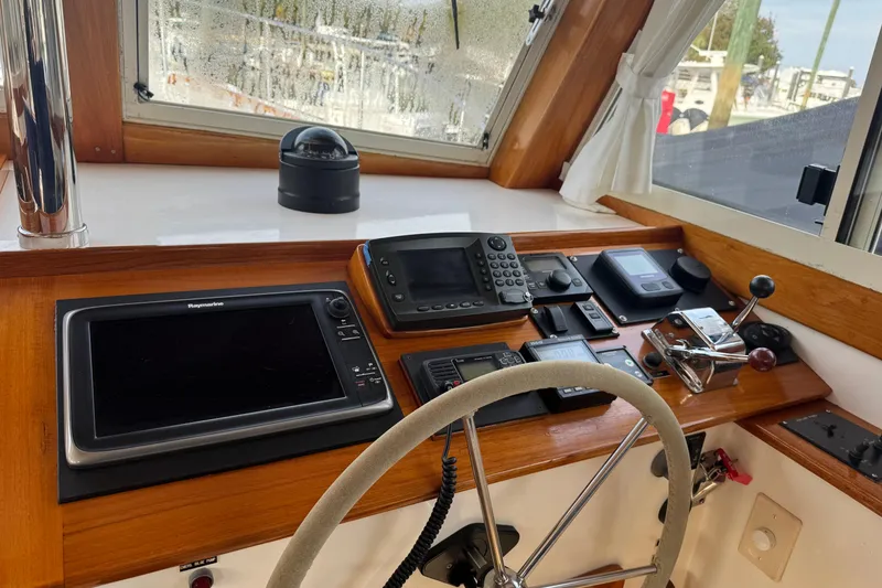 Slide: The Image of Helm of 2001 Ellis 36 Flybridge with navigation equipment and steering wheel. - 28