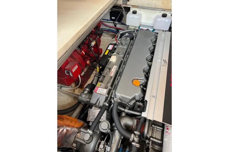 Slide: The Image of Engine compartment of a 2001 Ellis 36 Flybridge boat, showcasing detailed machinery. - 35