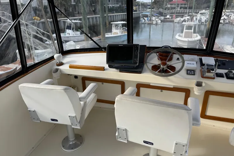 Slide: The Image of Flybridge helm of 2001 Ellis 36, featuring dual seats and navigation equipment. - 37