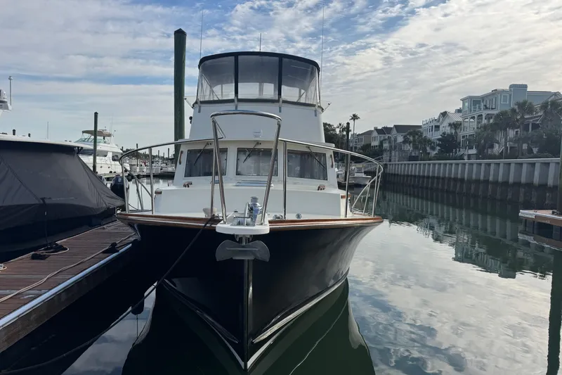Slide: The Image of 2001 Ellis 36 Flybridge yacht docked in a marina with waterfront homes. - 4