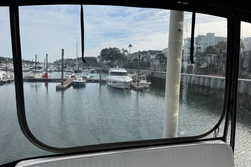 Slide: The Image of View from Ellis 36 Flybridge, 2001 model, overlooking marina with boats and waterfront homes. - 42