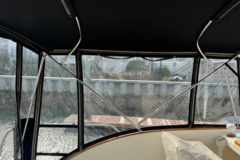 Slide: The Image of Interior view of 2001 Ellis 36 Flybridge boat with clear windows and dockside scenery. - 43