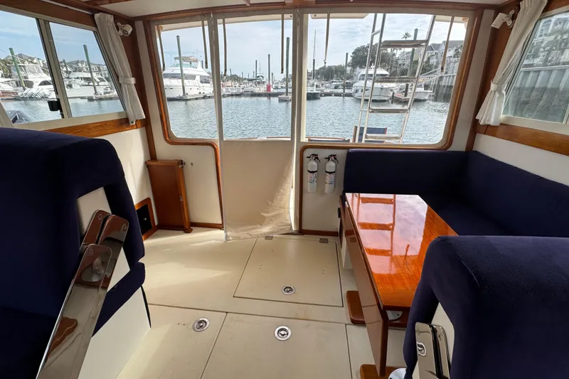 Slide: The Image of Interior of 2001 Ellis 36 Flybridge yacht with marina view through windows. - 46