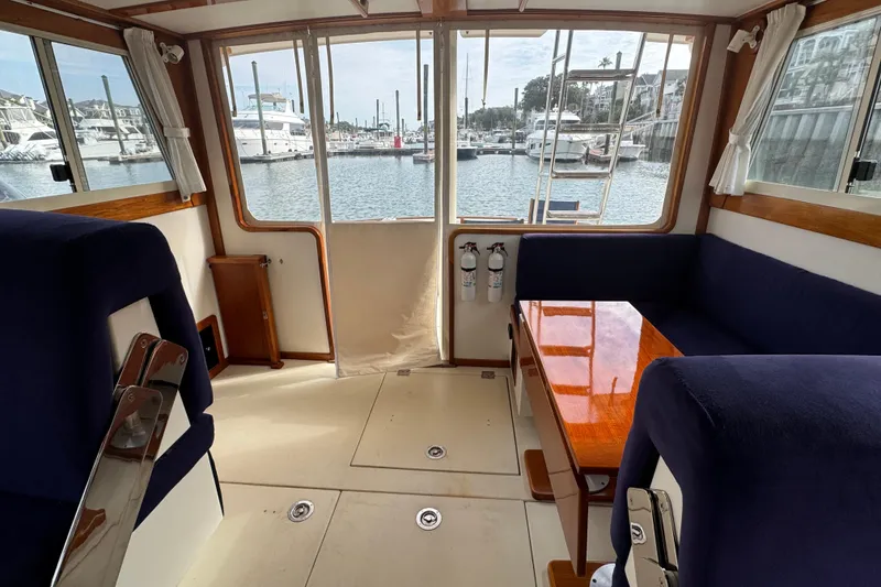 Slide: The Image of Interior of 2001 Ellis 36 Flybridge yacht with marina view through windows. - 47